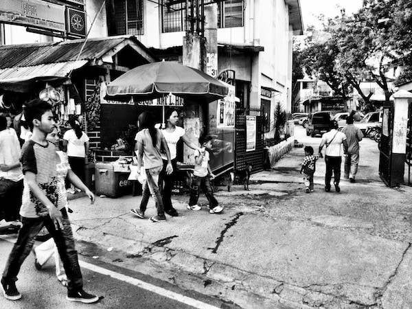 Black and white photo of people on a street.