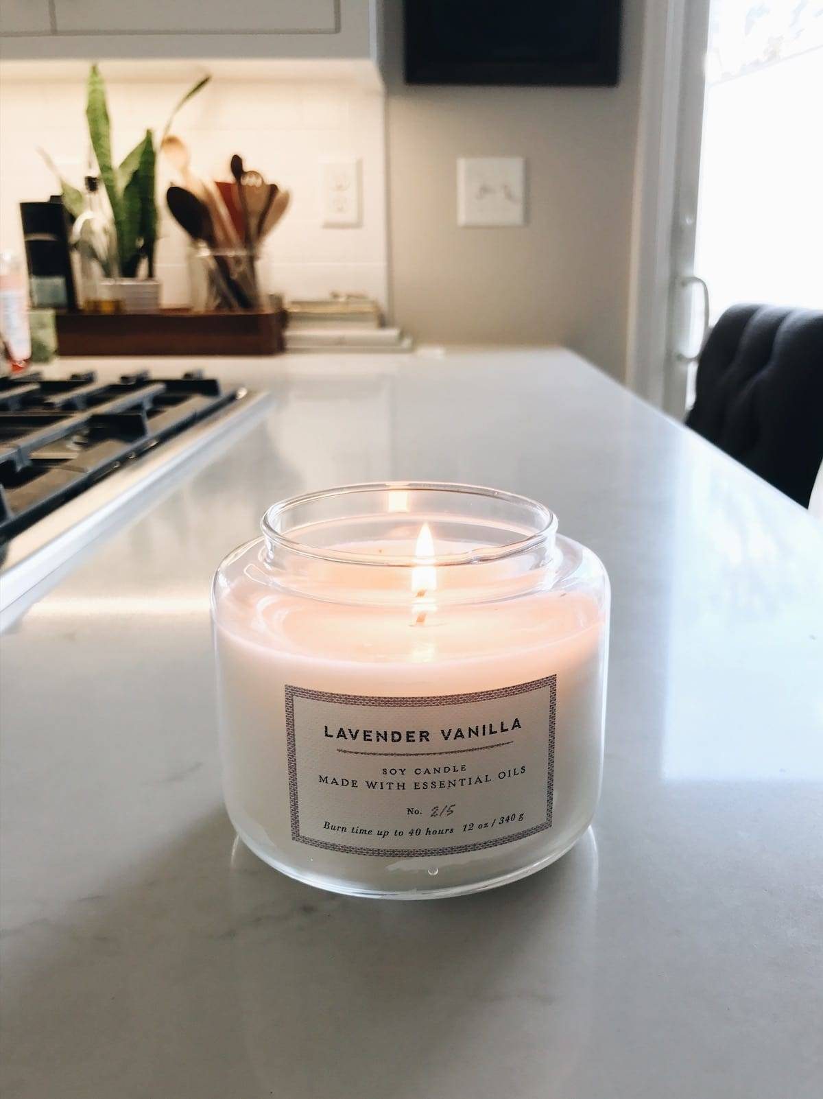 Soy vanilla candle in a glass container.