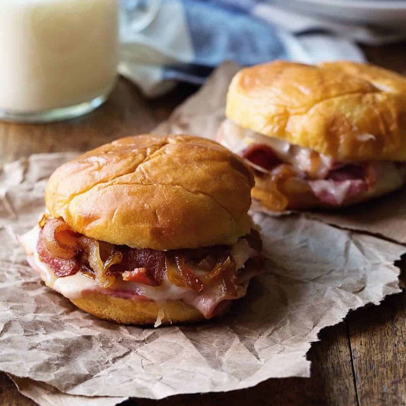 A picture of Hot Ham and Cheese Sandwiches with Bacon and Caramelized Onions