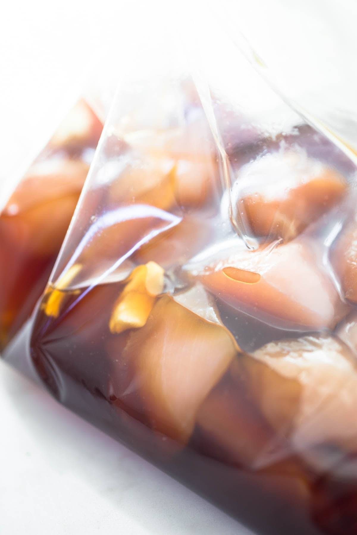Marinating chicken in a plastic bag.