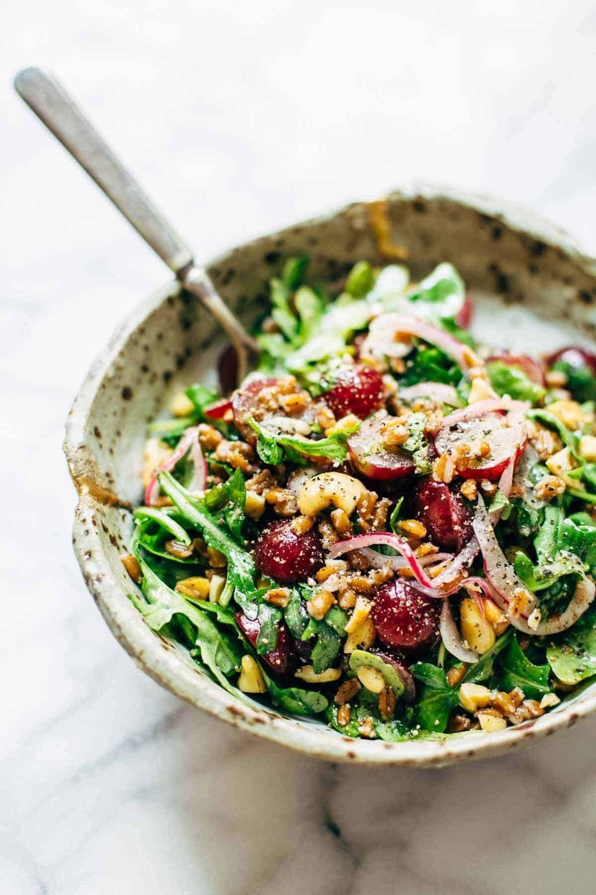 This Arugula Salad has grapes, cashews, pickled red onions, and a simple black pepper vinaigrette. Vegan, vegetarian, gluten free. | pinchofyum.com