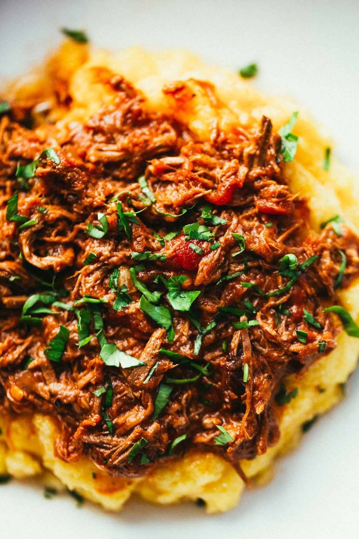 Crockpot Braised Beef Ragu with Polenta and herbs.