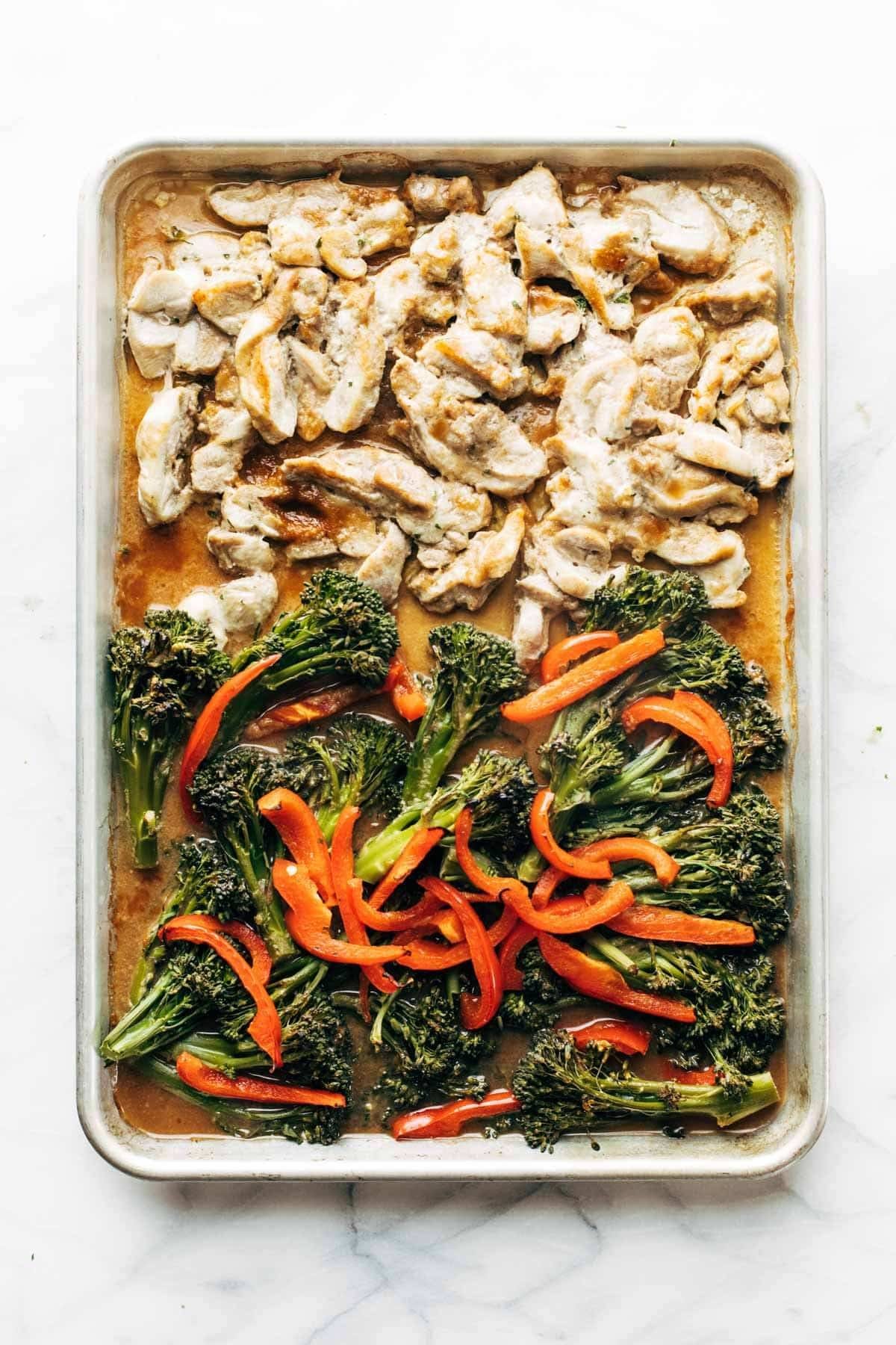 Roasted chicken, broccoli, and peppers on a sheet pan