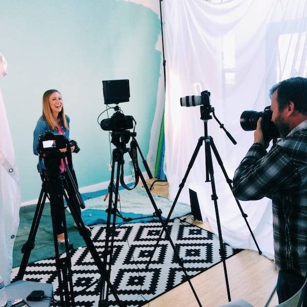 Woman behind cameras.