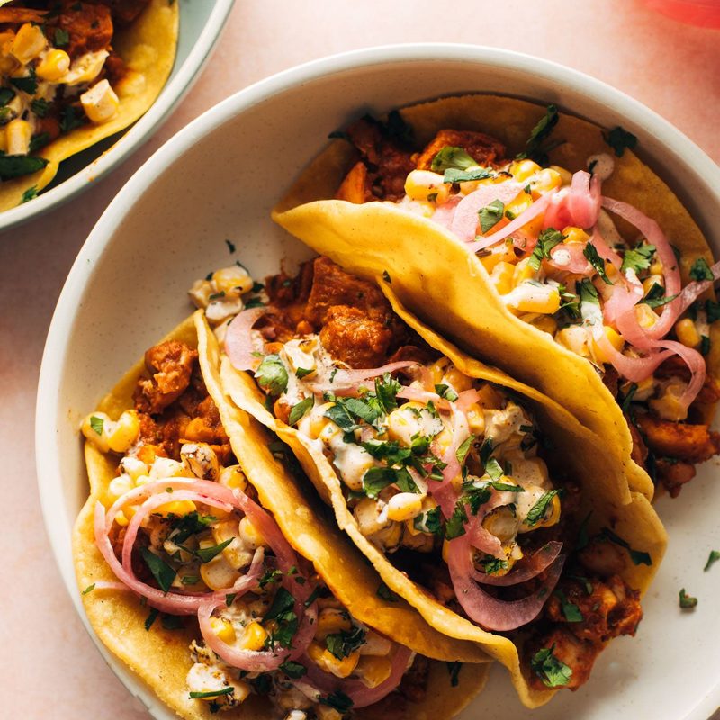 Chicken tacos on a plate with creamy corn