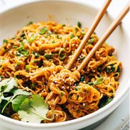Gochujang noodles in a bowl with chopsticks.