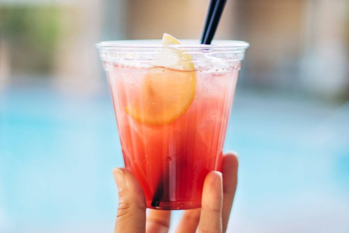 Pink drink with black straw.