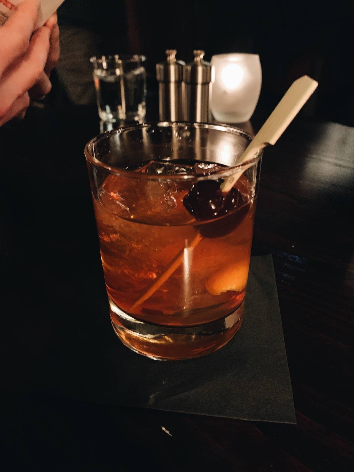 Cocktail in a clear glass with a cherry in it.