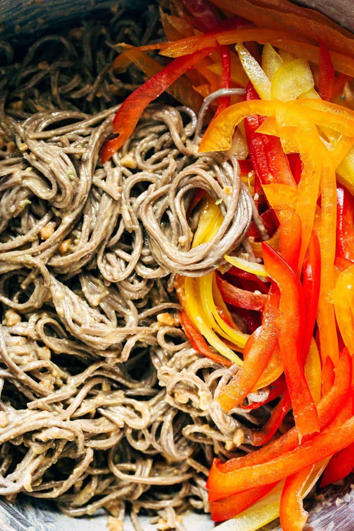 Close-up of soba noodles and bell peppers.