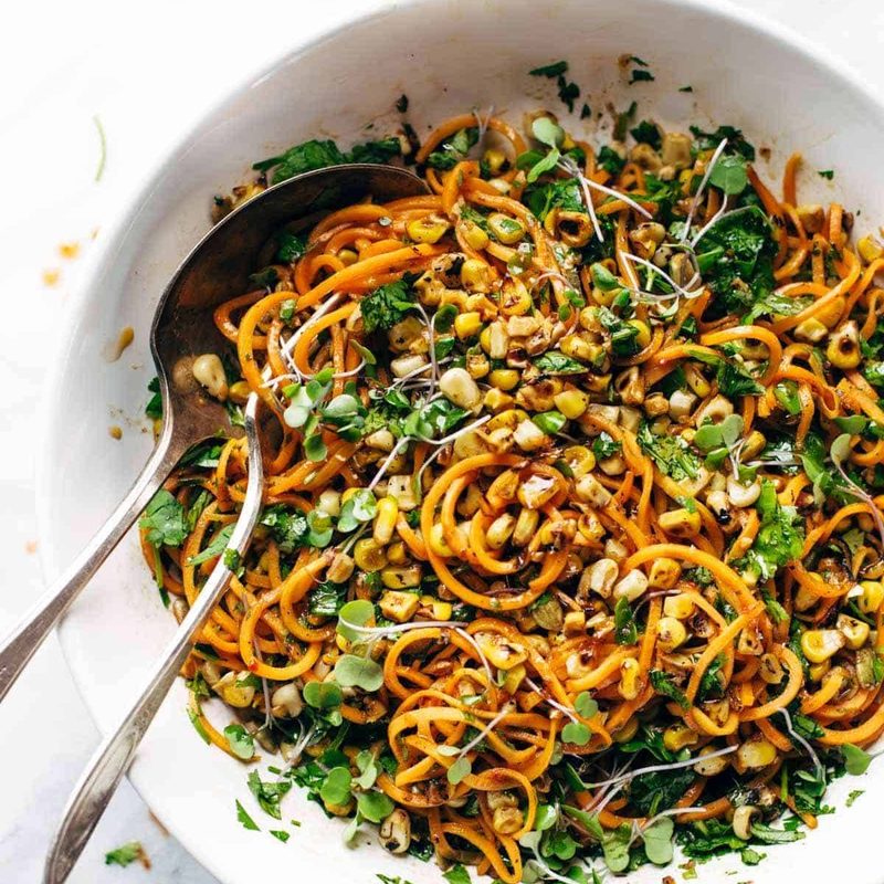 Sweet Potato Noodle Salad in serving bowl with spoons.
