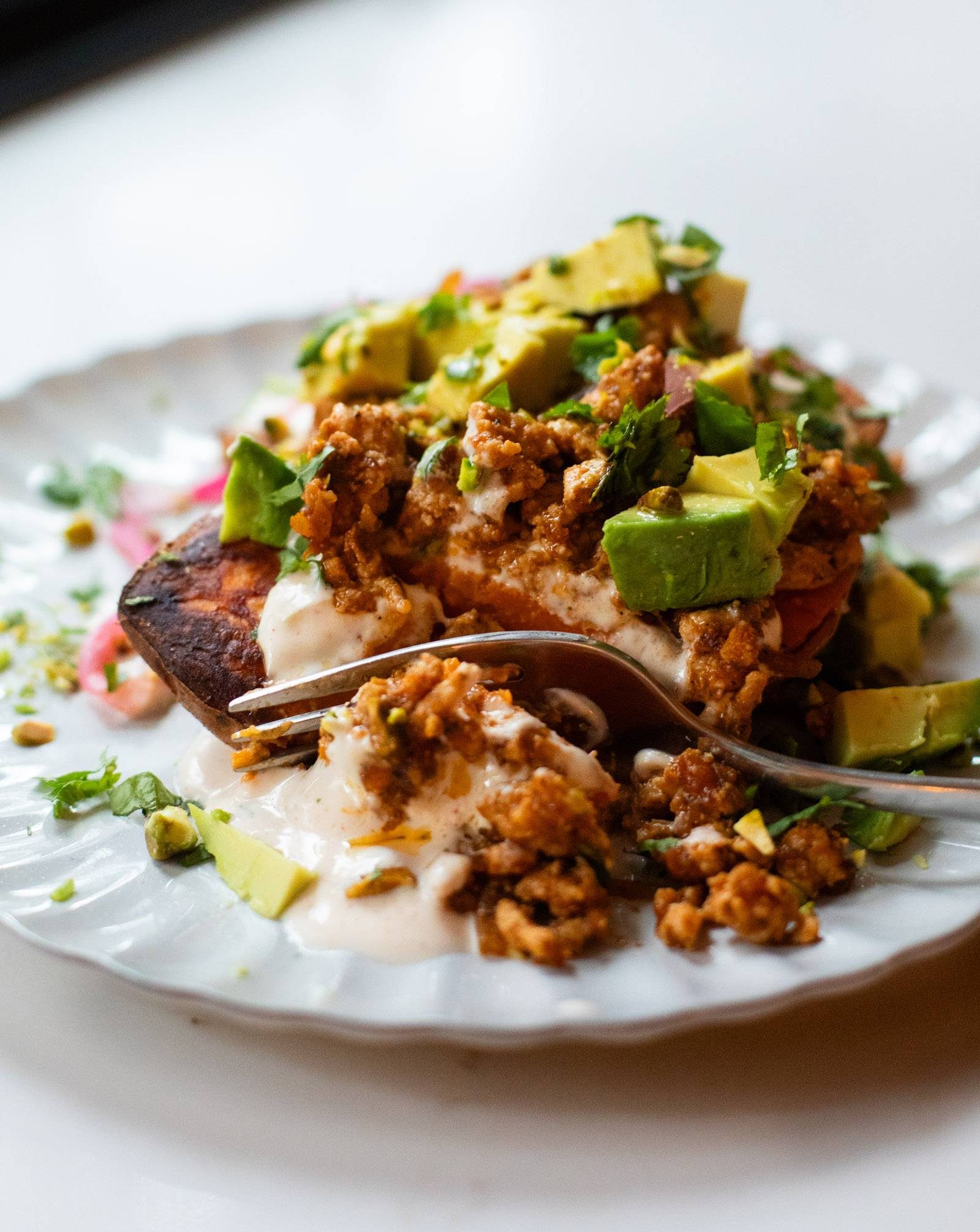 Sweet potato topped with ground chicken and avocado.