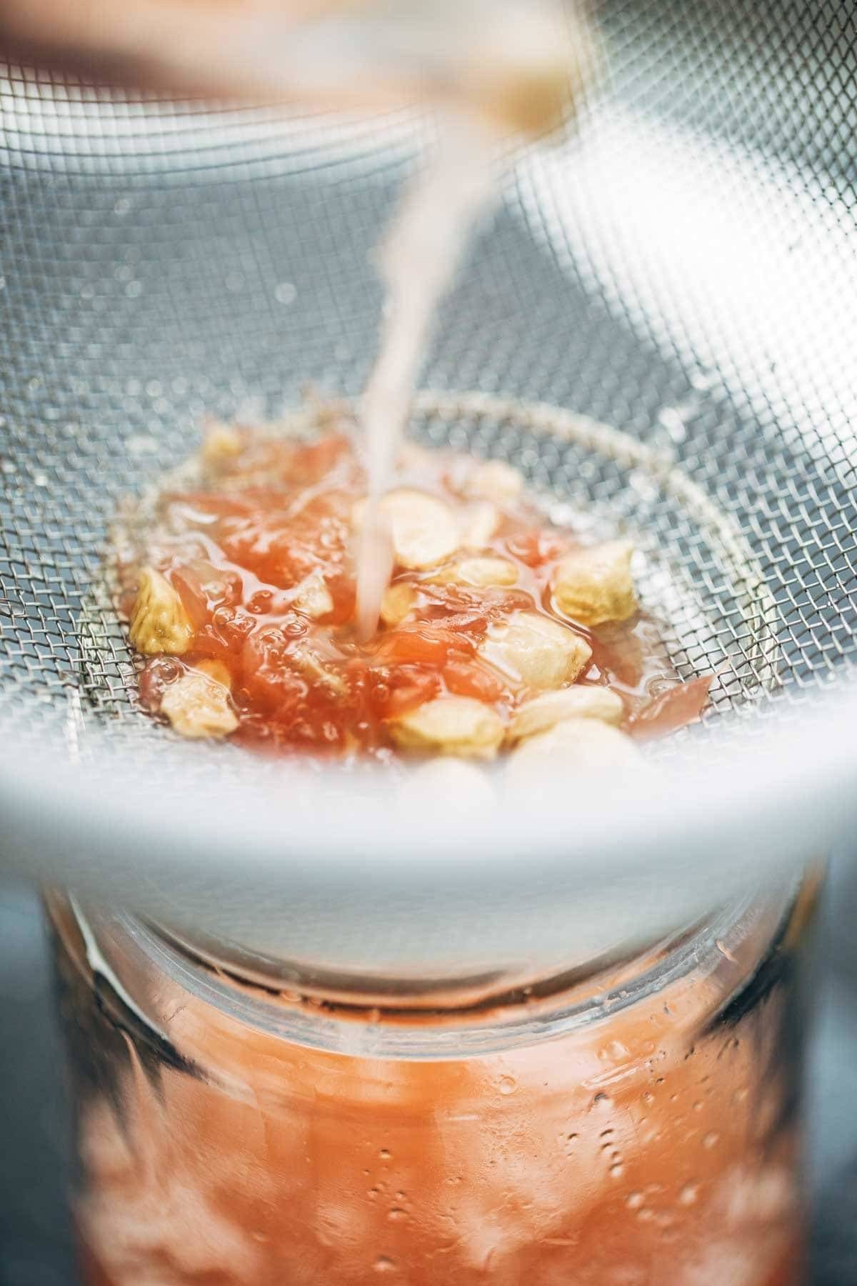 Grapefruit juice in a strainer.